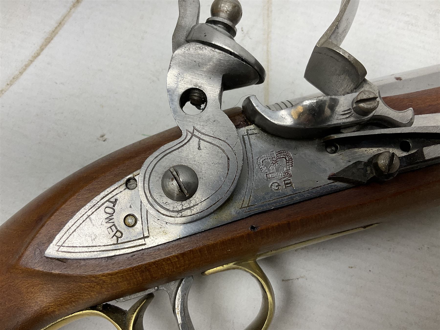 Reproduction non-firing flintlock pistol with brass skull crusher butt, the lock-plate inscribed 'Tower' and 'GR' L40cm; Sabre Japan Original Bowie Knife in sheath; and Indian embossed nickel two-piece walking cane (3)