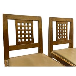 'Rabbitman' set of eight oak dining chairs, pierced lattice backs, upholstered seats with studwork band, octagonal front supports joined by stretchers, carved with rabbit signature, two carvers and six side chairs, by Peter Heap of Wetwang