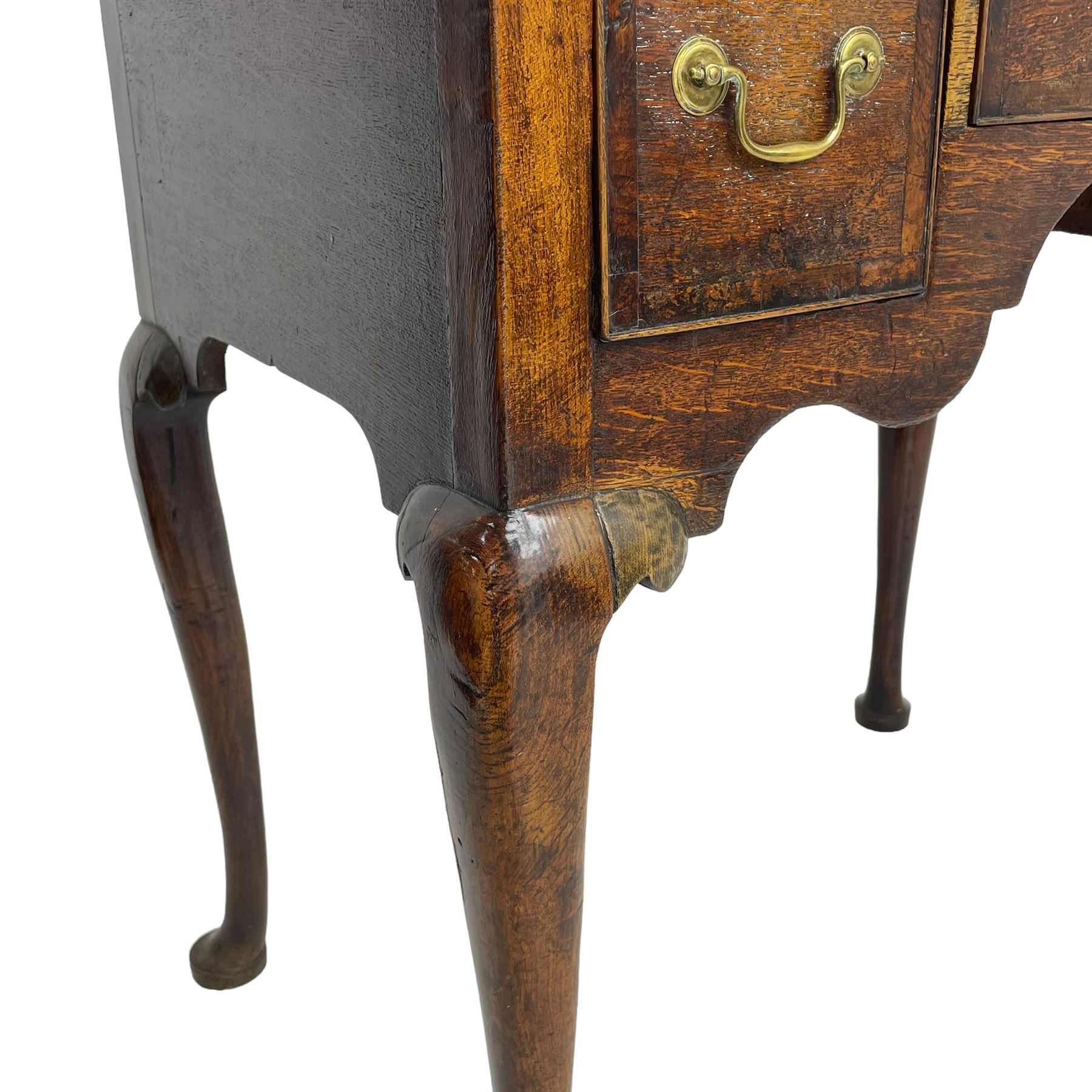 18th century oak low-boy, rectangular top over three crossbanded and cock-beaded drawers, ogee and stepped arch apron, on cabriole supports 
