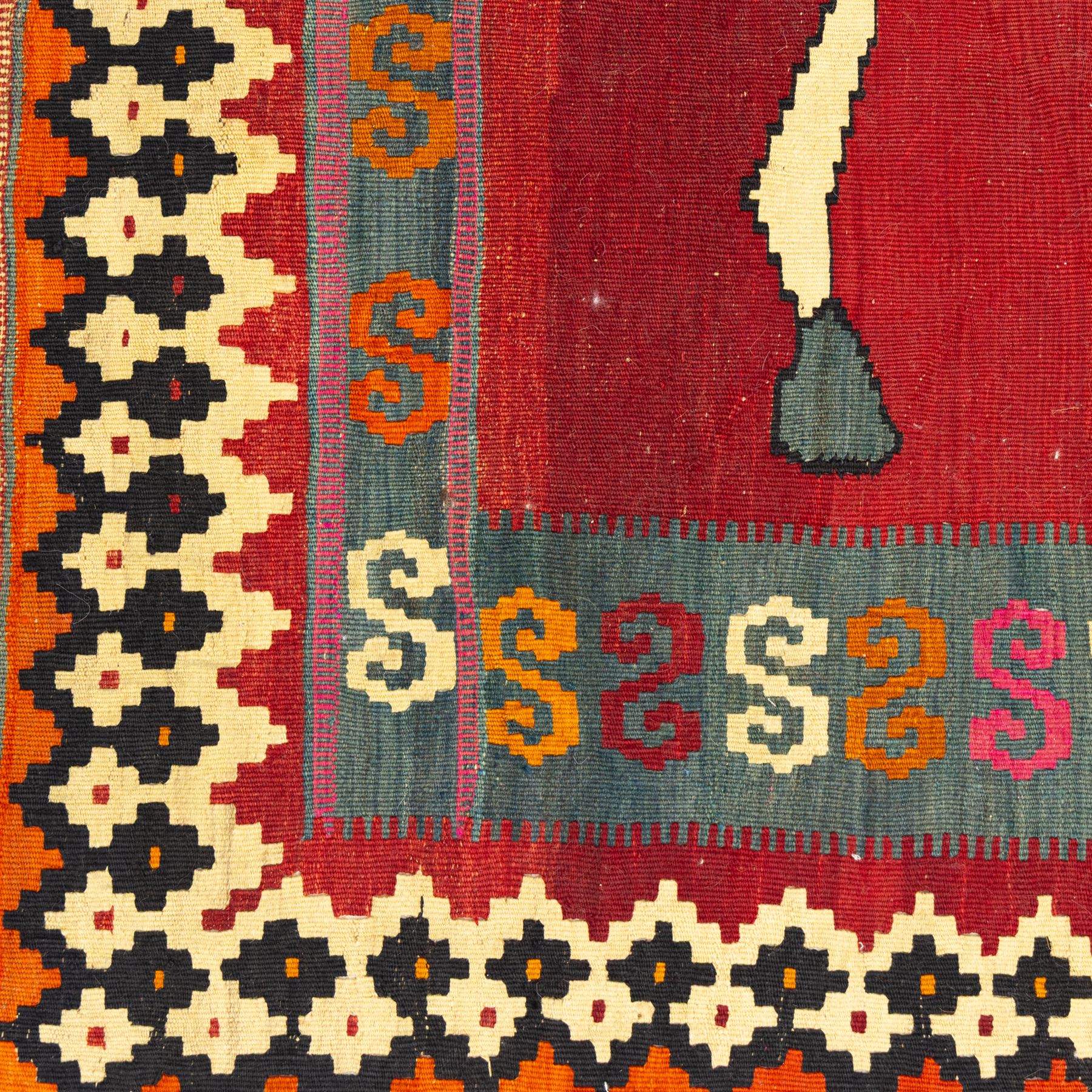 Southwest Persian Qashqai kilim, flatwoven wool with central pictorial design of mirrored horses on a red ground, framed by multicoloured motifs and stepped ivory border, vibrant palette throughout