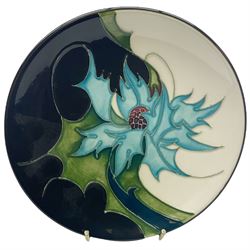 Moorcroft dish, decorated in the Thistles pattern designed by Eric Kals, with impressed and painted marks beneath, D16cm. 