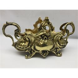 Ornate brass centrepiece, with twin handled vase upon a mirrored base, with floral and scrolling decoration, H23cm 