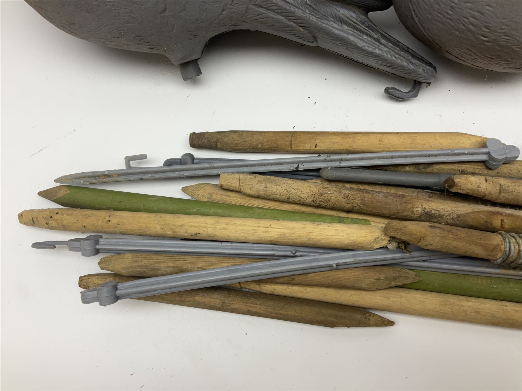 Eighteen plastic pigeon decoys comprising ten full body and eight shells with quantity of various stakes; some marked made in Italy