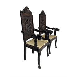 Pair early 20th century Indian Kashmiri hardwood armchairs, the cresting rail and back decorated with carved and pierced dragon, carved with traditional symbols and script, the arms carved with foliage and terminate into dragon masks 