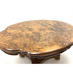 Victorian and later highly figured walnut breakfast table, shaped moulded tilt top with quarter matched veneer, the skirt decorated with carved scroll mounts, faceted baluster column on platform, turned feet with recessed castors, H73cm, 154cm x 122cm