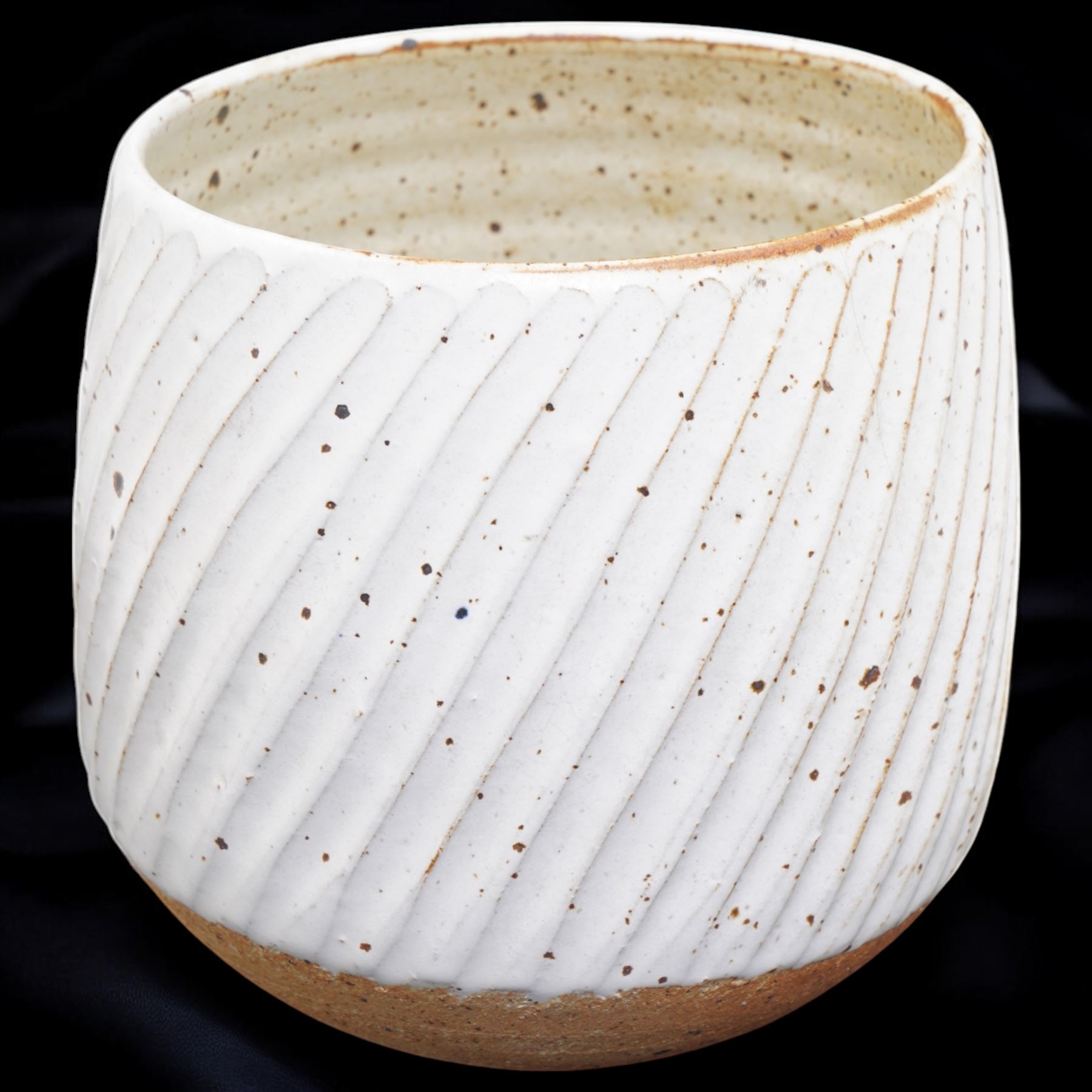 Joanna Constantinidis (1927-2000); studio pottery stoneware vase with fluted body, in a white glaze with brown speckles, impressed C mark to base, H20cm 