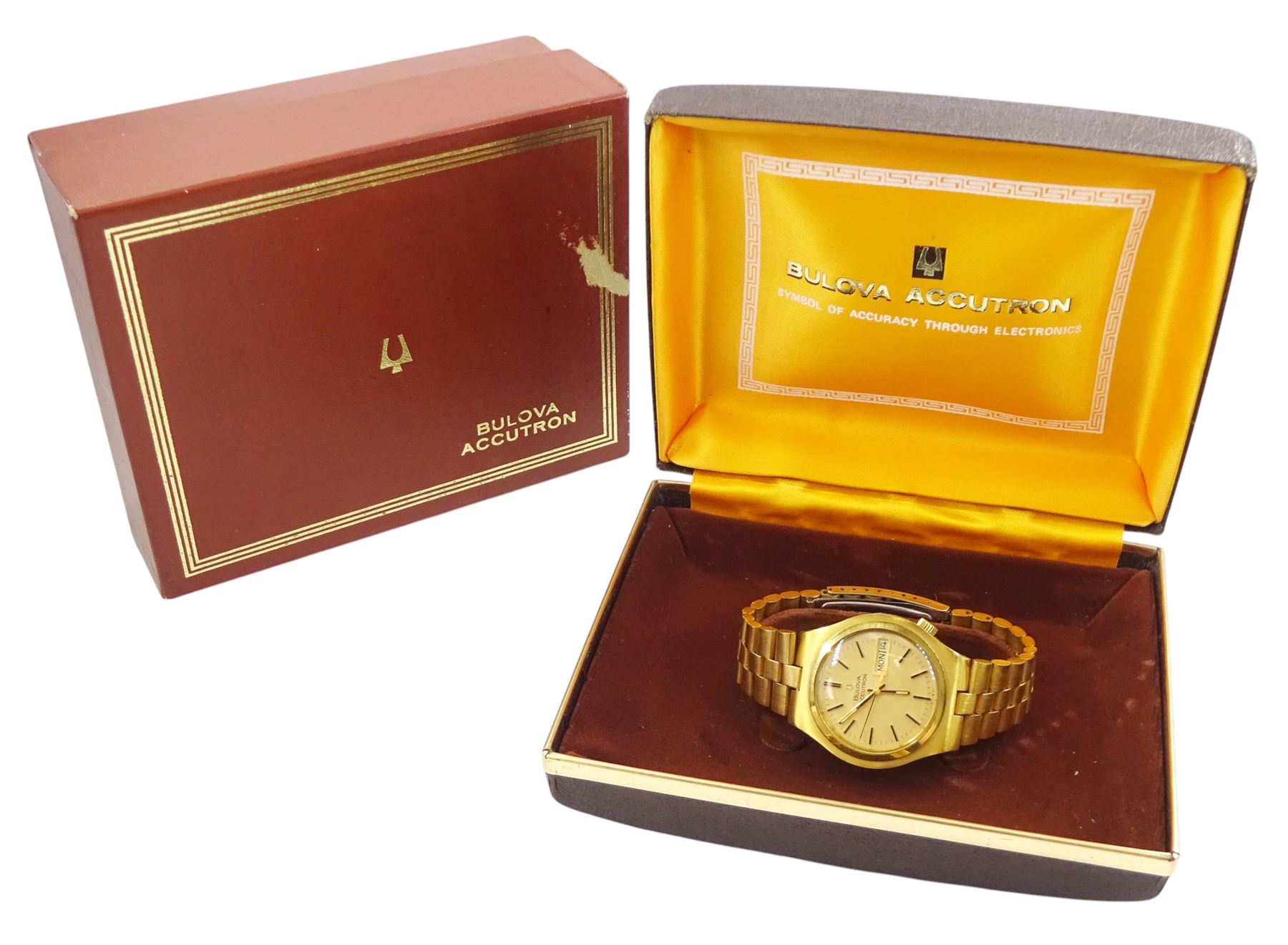 Bulova Accutron gentleman's gold-plated and stainless steel quartz wristwatch, Ref. 7083-5, Cal 21826, champagne dial with baton hour markers and day / date aperture, on original gold-plated bracelet, with fold-over clasp, boxed
