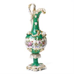Pair of mid-19th century Jacob Petit ewers, in the Rococo Revival style, hand-painted with panels of flowers on a green ground and heightened profusely with gilt, JP mark in underglaze blue to base, H25cm