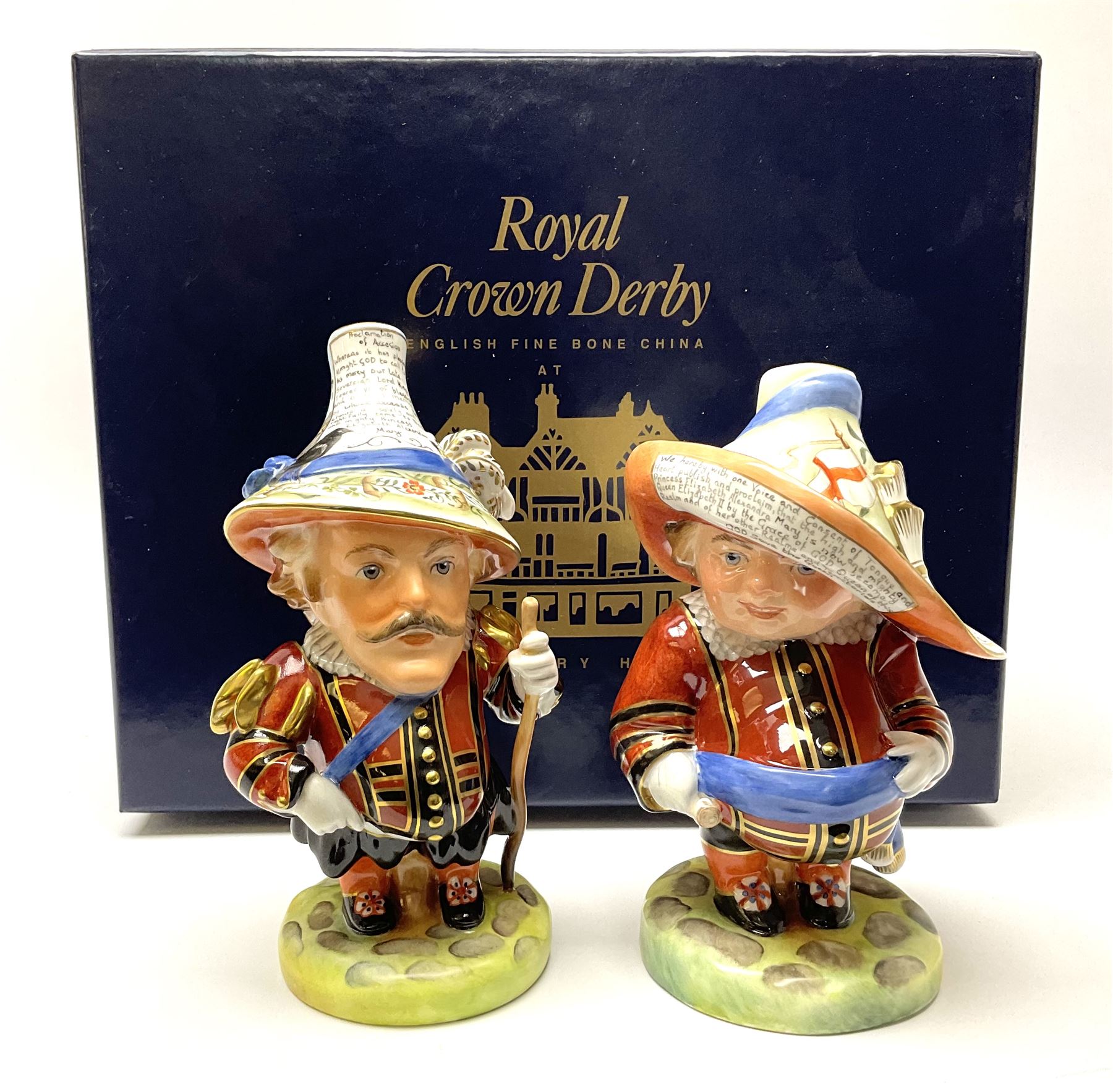 Pair of limited edition Royal Crown Derby Golden Jubilee Mansion House Dwarfs, Tall and Low Dwarf, dressed in Royal Guard uniform, H18cm, exclusive to Mulberry Hall 35/50, each with printed mark beneath, and signed M.E.Reynolds and J Morrison, with makers box. 