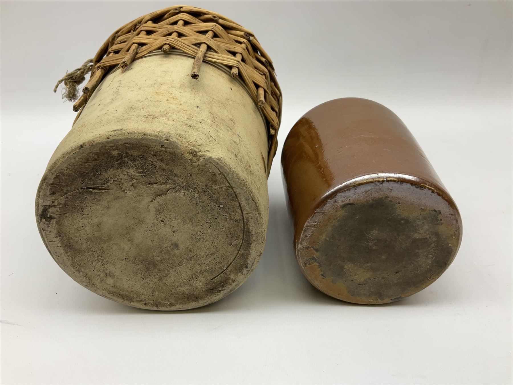 19th century stoneware gin bottle impressed I. Peck, Spirit Merchant Hull H27cm, Victorian salt glazed stoneware jar embossed W. Jefferson Mustard Manufacturer 47 Wincolmlee Hull, part cane covered stoneware flagon for John Smith Market Place Beverley and a Barton-on-Humber stoneware ginger beer bottle (4)  