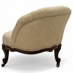 Late 19th century Victorian walnut button-back recamier, asymmetrical form, with cream damask fabric and gimp braid edging, shaped reeded apron above front and back scroll carved cabriole legs on brass castors