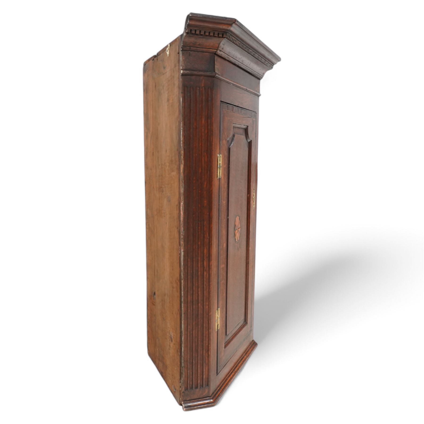 19th century mahogany corner wall cupboard, with projecting cornice and dentil moulding above a single door with shaped fielded panel and satinwood fan inlay, flanked by fluted pilasters, fitted with shaped interior shelving