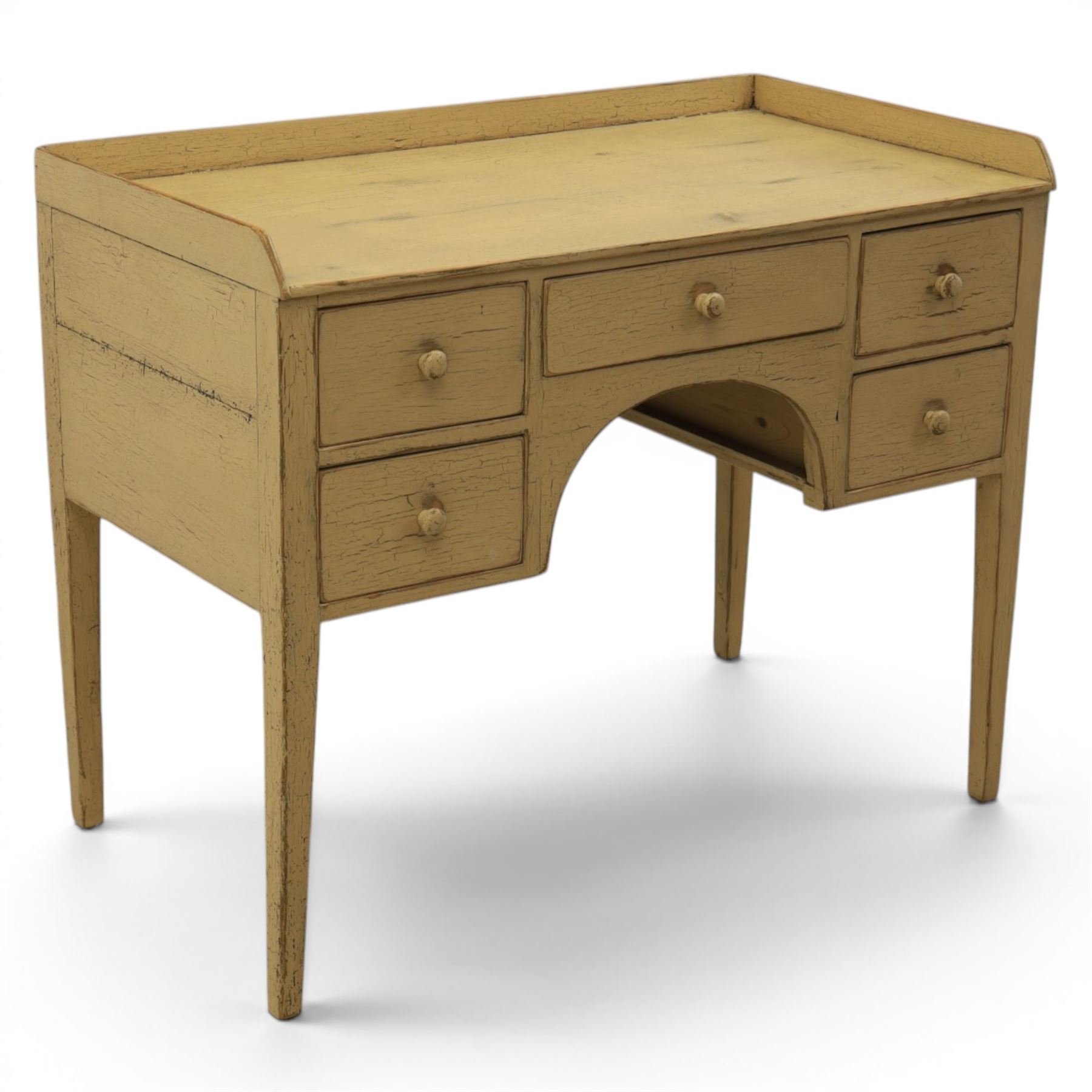 Pine country writing desk, rustic cream paint finish, galleried top over a central drawer flanked by two drawers, tapered square supports