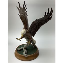 Three Franklin Mint figures, first example On The Prowl, on wooden stand H32cm, L63.5cm, Grizzly, H23cm and American Majesty by Ronald Van Ruyckevelt H37cm, together with five other figures.  