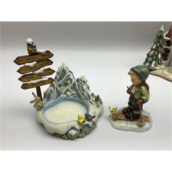 Eight Christmas Hummel figures by Goebel, to include Wintertime Chapel candle holder, Winter Fun, Christmas Morning, Christmas Time and Gingerbread Lane, tallest H21cm