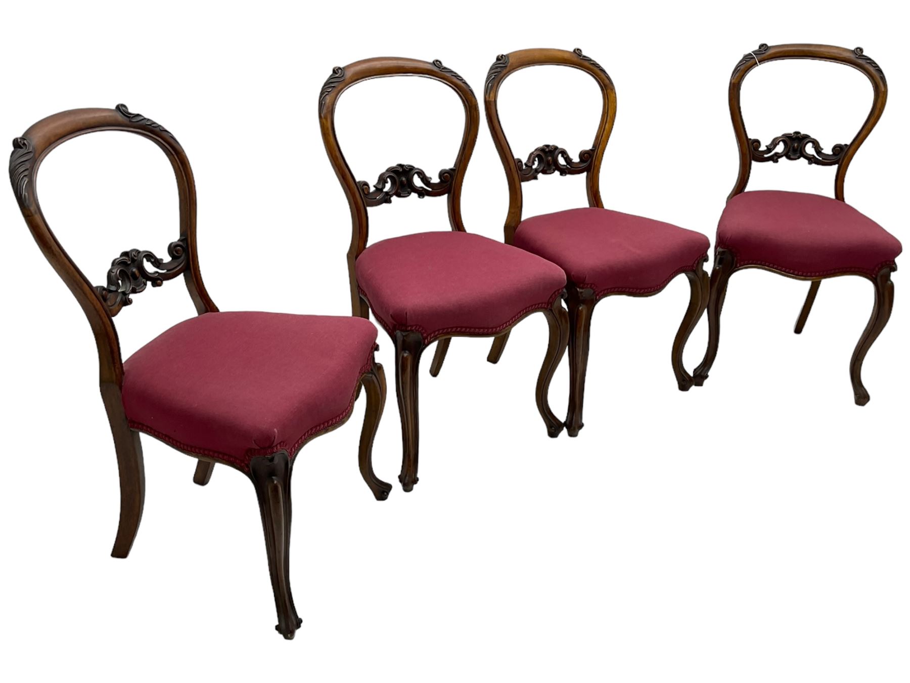 Set of six Victorian rosewood dining chairs, the balloon back carved with foliage scrolls, cartouche carved middle rail with extending scrolls, the seats upholstered in pink fabric, on carved cabriole supports with scrolled terminals 