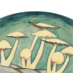 Moorcroft Fairy Ring plate, 1990, decorated with mushrooms upon a green ground, with painted and impressed marks beneath, D26cm