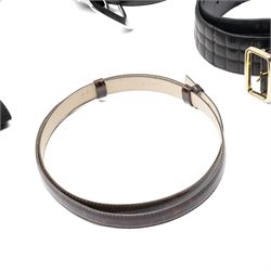 Collection of belts, including white Nike Golf leather belt with oval green and silver Nike swoosh buckle, white Nike leather belt in perforated pattern, black Aigner crocodile-embossed leather belt with large gold buckle, black Jaeger quilted leather belt with rectangular gold buckle, etc (10)