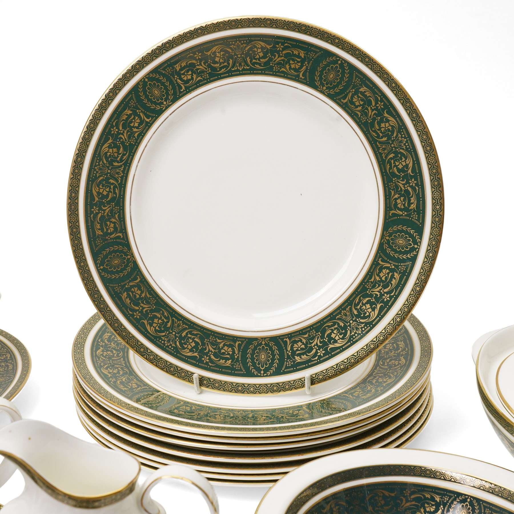 Royal Doulton Vanborough pattern part dinner service, comprising two covered vegetable dishes, open vegetable dish, eight dinner plates, oval serving dish, six soup bowls and two further bowls, eight side plates and eight dessert plates, six coffee cans and saucers, milk jug and a gravy boat and stand