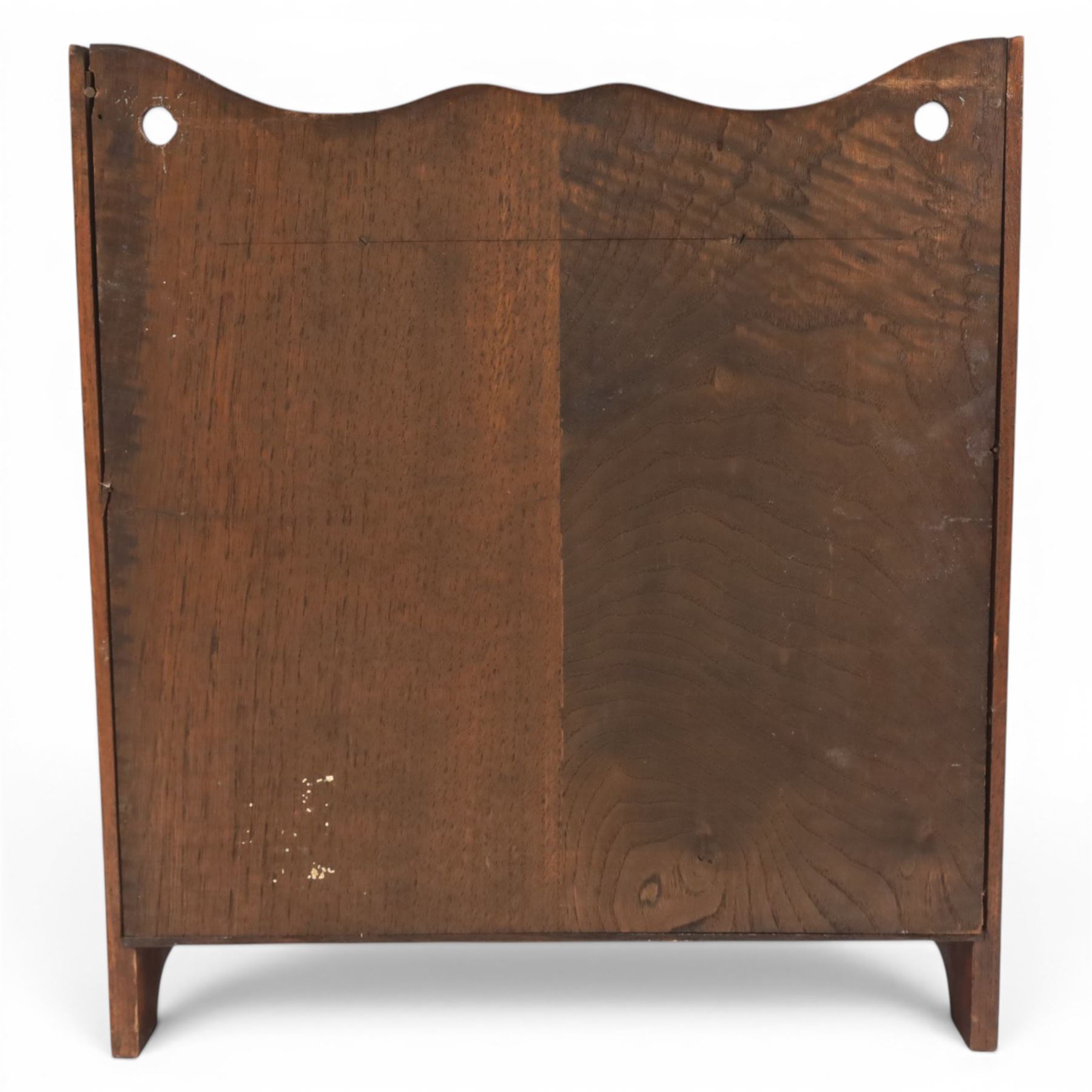 19th century oak table top smokers cabinet, with carved foliate pediment, the two beveled edge glass doors opening to reveal a fitted interior, with four drawers and fitted brass of pipe holders to each door, H46cm