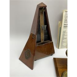 French Maelzel Paquet mahogany cased metronome of typical pyramid form with clockwork movement H22cm; and a set of Criterion brass postal scales on oak base with inset brass weights; in original box with paperwork (2)