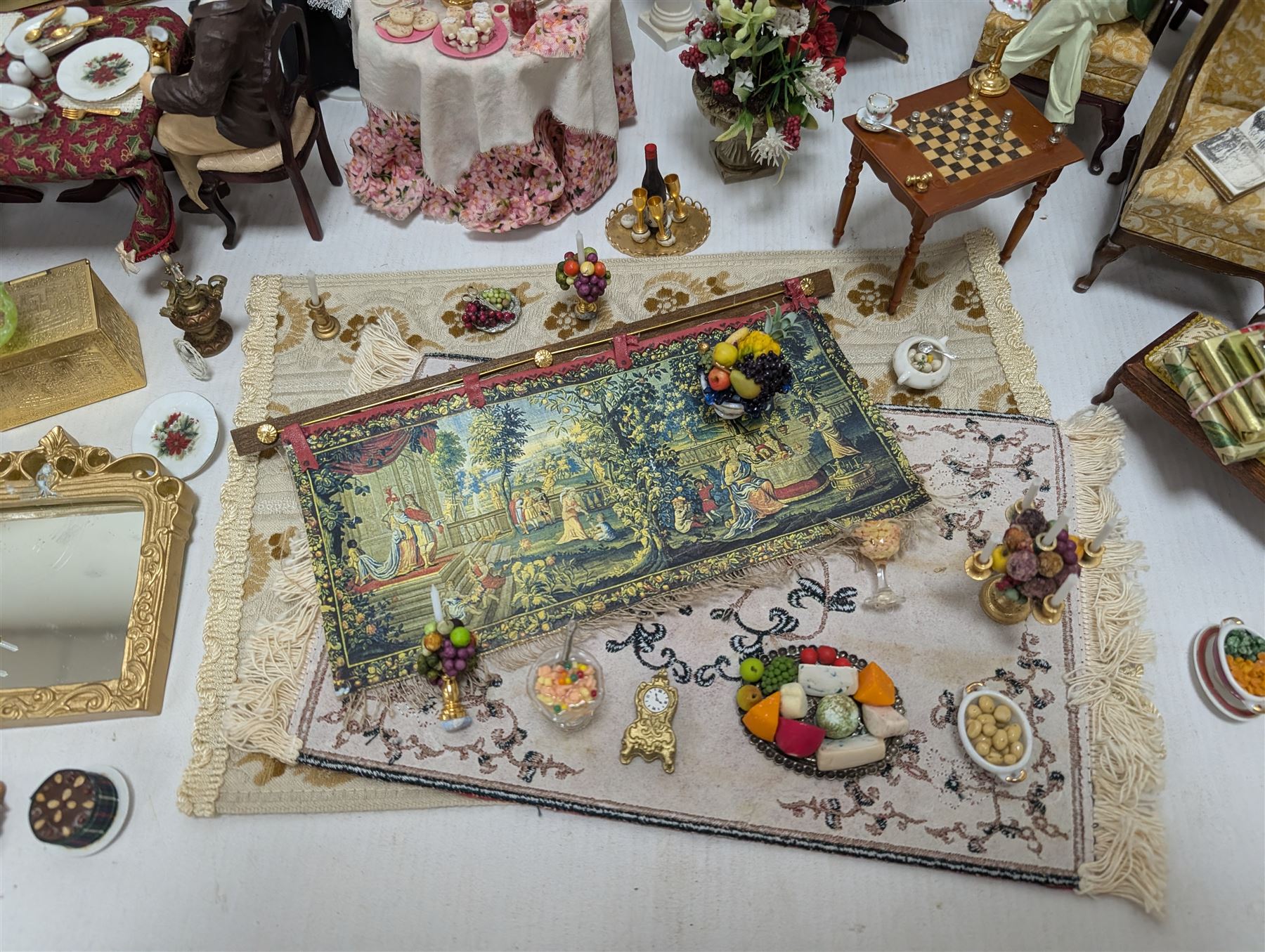 Dolls house living room and dining room furniture, including arm chairs, desk, fireplaces, dressers, tables, eight figures and a large collection of predominantly Christmas themed food, accessories and decorations