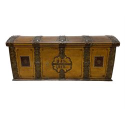 19th century painted oak sea chest, hinged dome top enclosing small compartment, bound by shaped and pressed metal strapwork, scumbled finish to resemble oak and painted with small vignettes depicting portraits and landscapes within panels, fitted with large wrought metal carrying handles, the front inscribed 'H.J.S. 1870' 