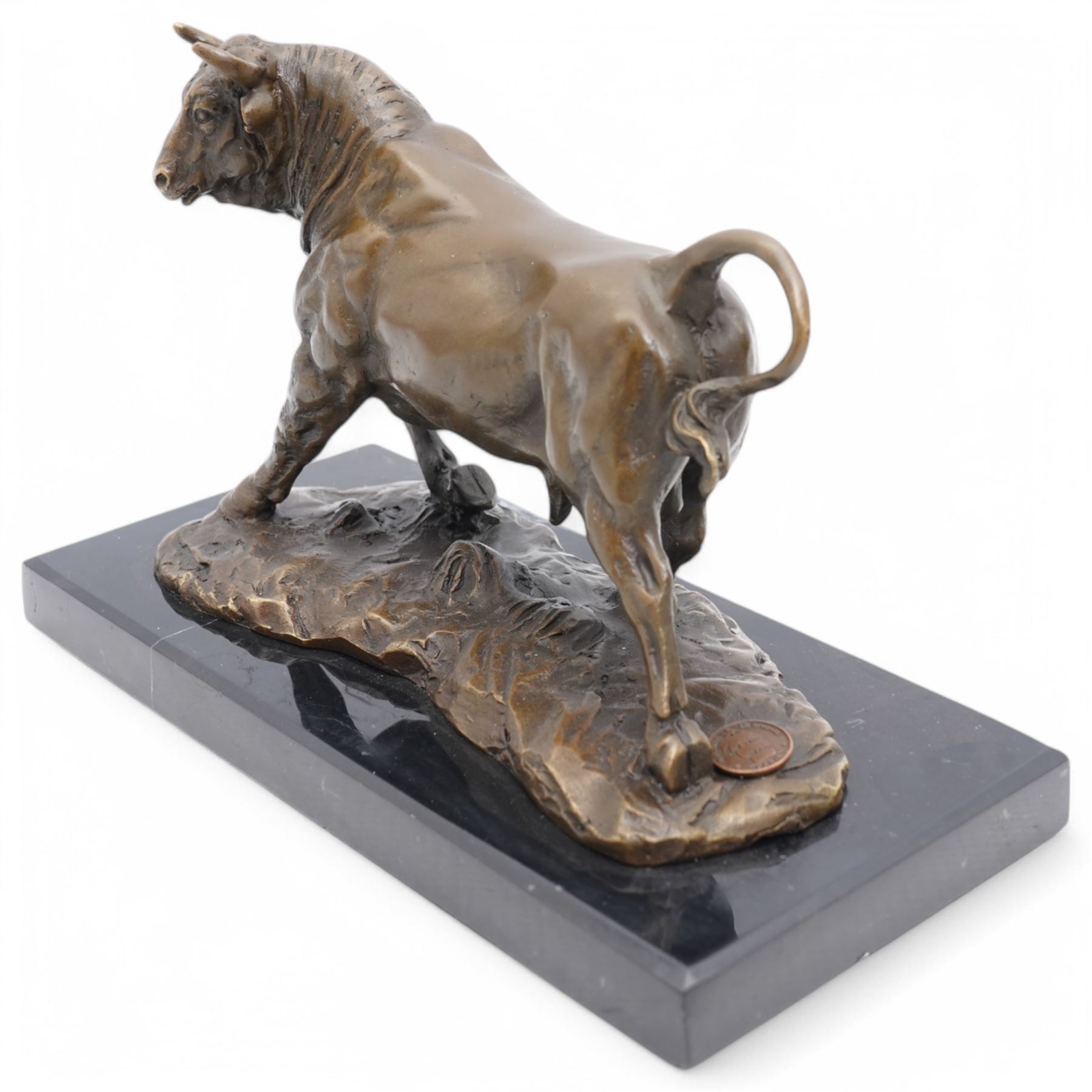 Bronze figure, modelled as a prancing bull, upon a rectangular marble base, bearing foundry stamp, overall H14cm L21cm

