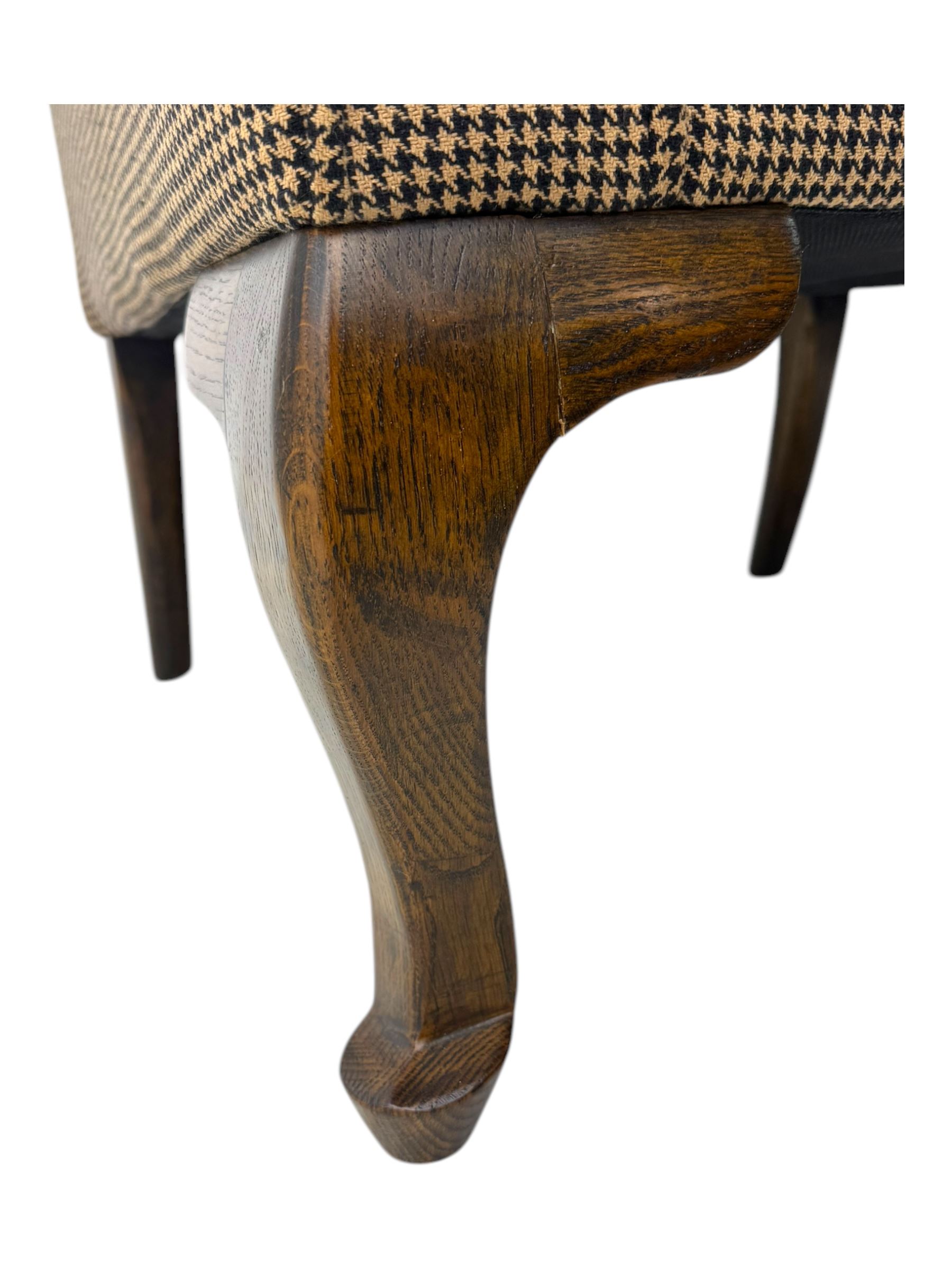 Hardwood-framed wingback armchair, upholstered in dog tooth pattern fabric, on cabriole supports 