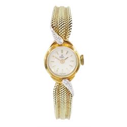 Ebel ladies 14ct gold manual wind diamond wristwatch, silvered dial with baton hour markers, a row of diamonds set each side of the case, on integrated 14ct gold bracelet, stamped 585