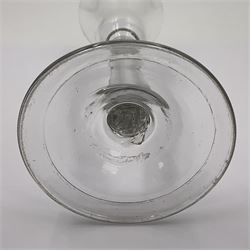 Three 18th century wine glasses comprising a plain stemmed glass with bell shaped bowl and conical folded foot H16cm, another plain stemmed glass with ogee bowl and folded foot and a Continental glass with gilt faceted bowl, decorated with male figure within a landscape, on a clear Silesian seven sided cut stem (3)