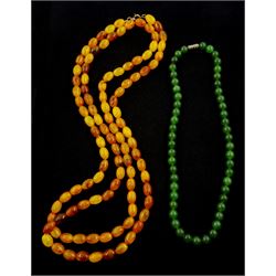 Long single strand amber type bead necklace and a nephrite bead necklace
