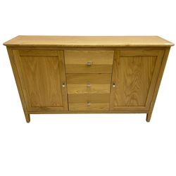 Contemporary light oak sideboard, fitted with three central drawers flanked by two panelled cupboards, on tapering supports