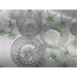 Quantity of glassware comprising three cut glass bowls with strawberry, fan and swags decoration, pair of servers with hobnail decoration handles, lidded decanter, jug and quantity of uranium glasses, tallest H30cm