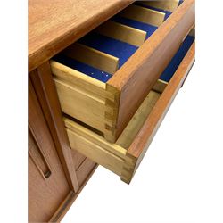 Nils Jonsson - mid-20th century teak sideboard, rectangular top over three-section base, left and centre sections with sliding double doors enclosing shelving, right section with four drawers, raised on tapered supports