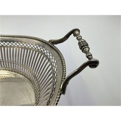 Early 20th century Dutch silver basket, of oval form with pierced sides, beaded rim, and twin handles, marked with Lion Passant for 2nd standard purity and date letter for 1910, other marks worn and indistinct, including handles H8.5cm L25.5cm