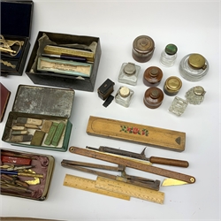 A selection of various writing accessories, to include a cased drawing instruments set, containging various dividers, compasses, and a folding rule, the case makred Cary Porter Ltd 7 Pall Mall London, a quantity of pen nibs, assorted inkwells, rubbers, and pens, etc., together with a selection of approximately forty postcards, to include a silk example. 