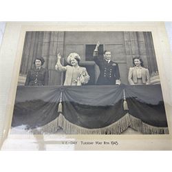 King George VI and Queen Elizabeth - the photograph and signatures only from a 1945 Christmas card depicting The Royal Family waving from the balcony of Buckingham Palace, on V-E Day Tuesday May 8th 1945, signed 'George R.I. Elizabeth R.'