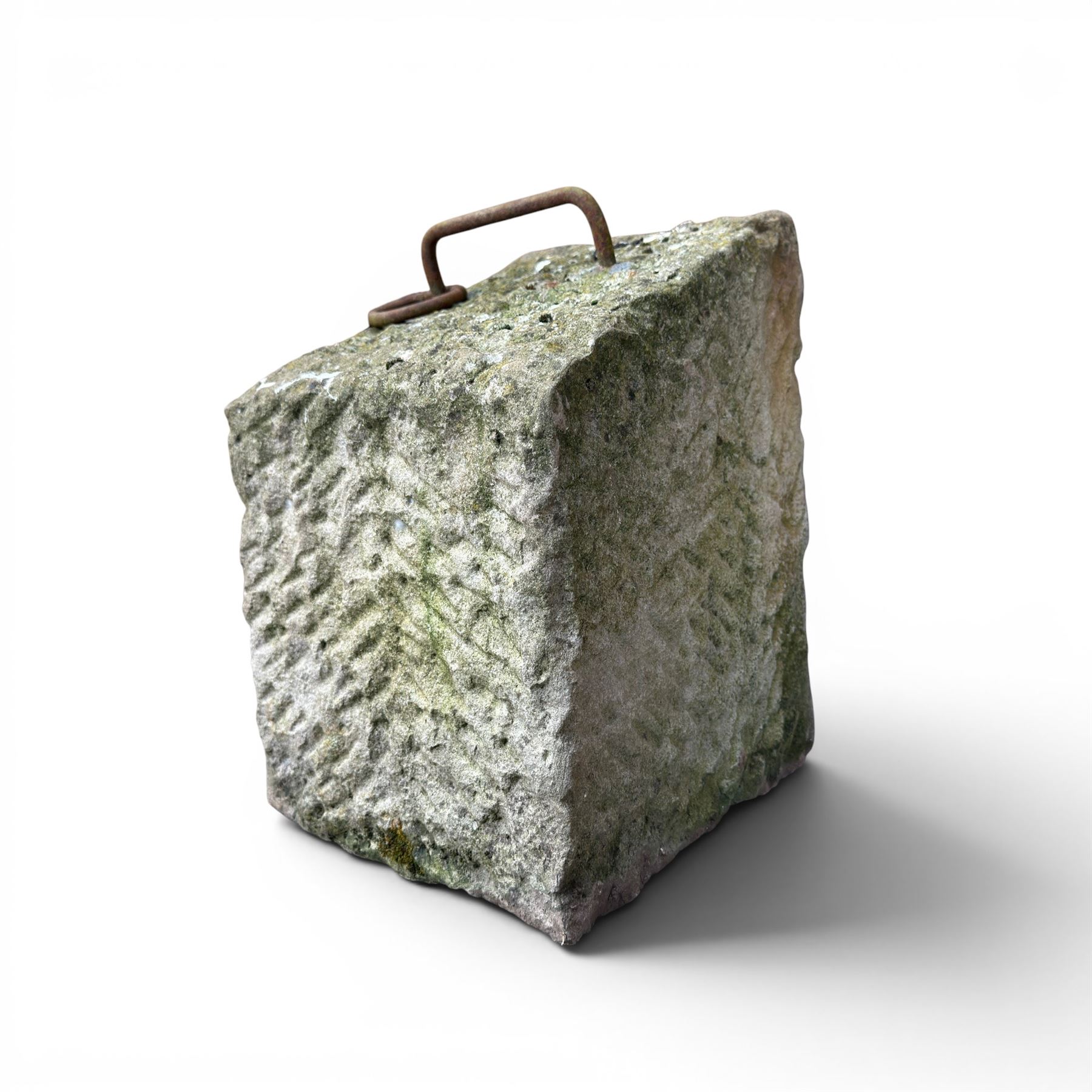 19th century carved tethering stone, square sloping form with iron work loop