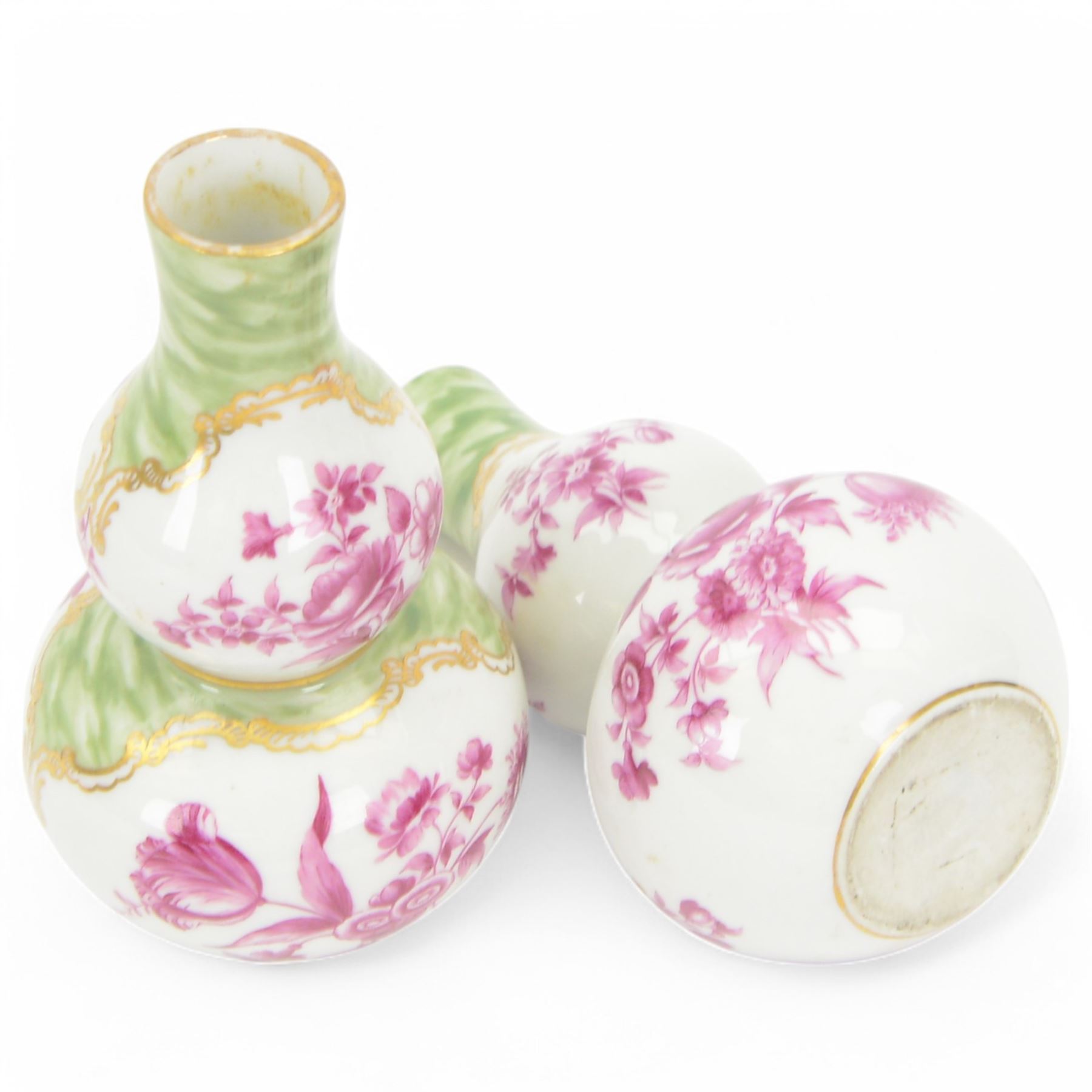 Pair of small late 19th century German double gourd vases, probably Dresden, each hand painted in puce with reserves of a courting couple within a garden setting, and floral sprays upon a white ground, within a green painterly surround, each with very faint traces of blue marks to the unglazed base, H12.5cm