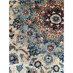 Persian Kashmar camel ground carpet, palmette rosette medallion on a field of curling leafy branches and stylised plant motifs, scrolling border decorated with further palmettes, within floral pattern guard stripes