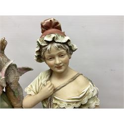 Pair early 20th century Royal Dux porcelain figures, modelled as a young girl carrying a basket of fish, and a young boy carrying game, on naturalistic bases, pink triangle marks, 41cm high (2)