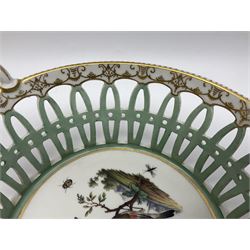Pair of 19th century German openwork chestnut baskets, with twin handles and scrolling gilt border and star rim, painted to the centre with birds and insects, D22cm 