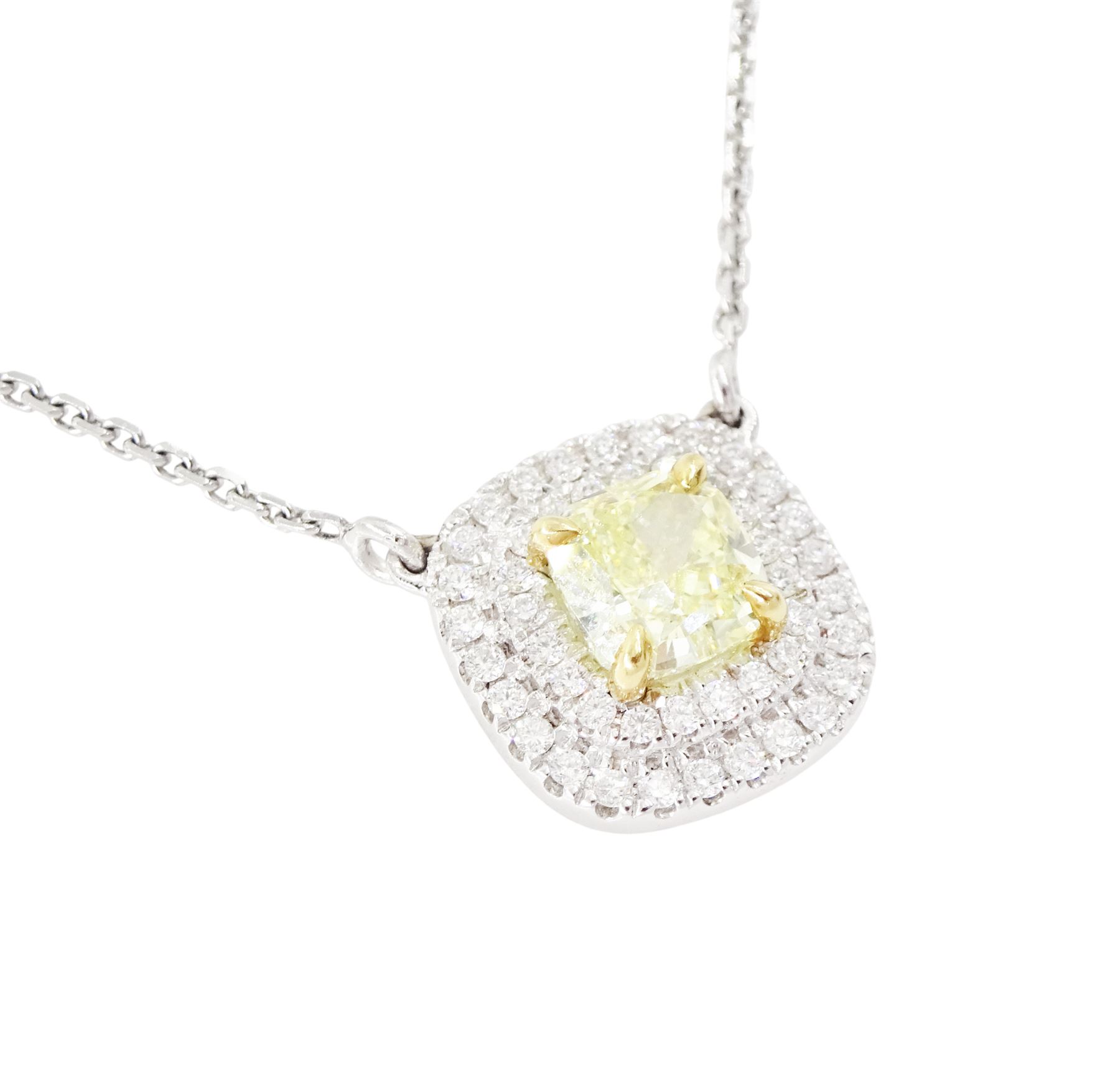 18ct white gold diamond pendant necklace, single cushion cut fancy yellow diamond of 1.05 carat, surrounded by a double halo of round brilliant cut white diamonds, to a fine trace link chain necklace, hallmarked, total white diamond weight 0.26 carat 