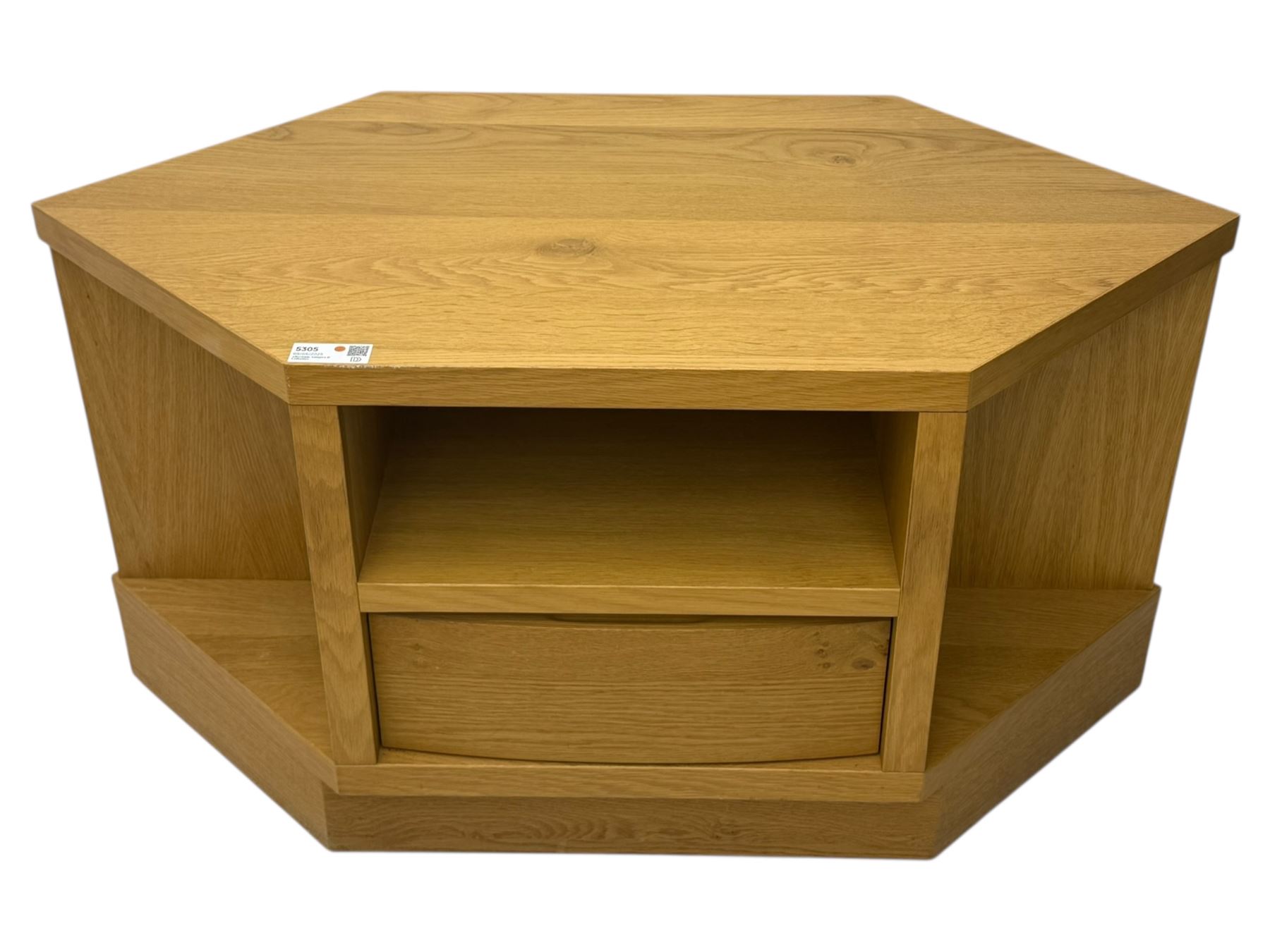 Contemporary light oak corner television stand, hexagonal top with central open section and lower drawer, shaped sides on integral plinth