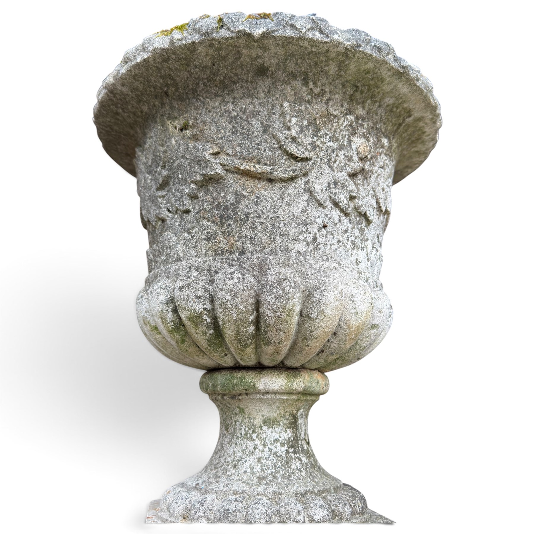 Set of four weathered composite stone urns of campana form, the everted leaf-moulded rolled rim over a body decorated with scrolling fruiting grapevines in relief, over a gadrooned underbelly and waisted socle, lobed collar on square base