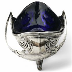 German standard 800 silver oval centrepiece with pierced sides, trailing harebells and swing handle, blue glass liner on splay feet L29cm Maker Wilhelm Binder