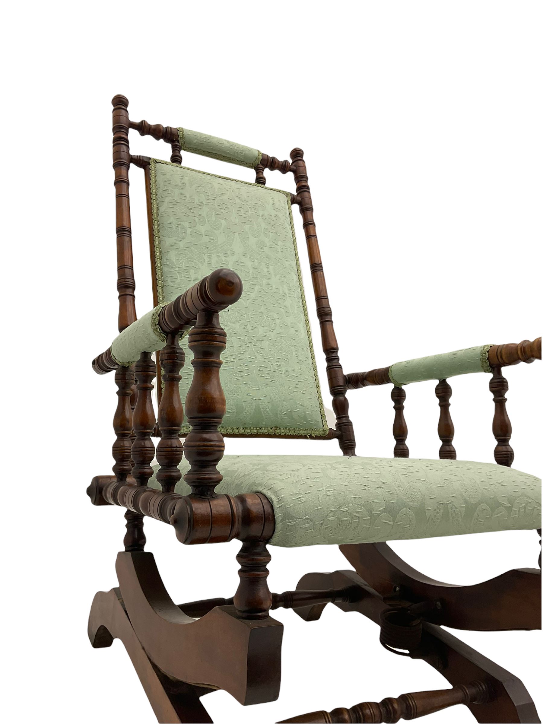 Early 20th century walnut framed American rocking chair, upholstered seat, back and arms