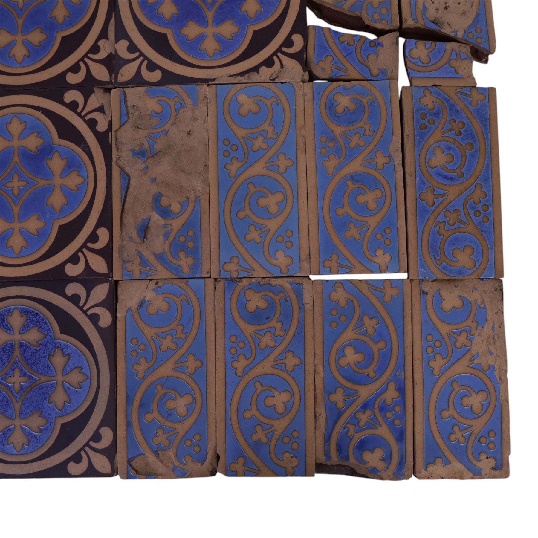 Minton & Co, Gothic Revival polychrome encaustic floor tiles, circa 1850, including six decorated with a central cardinal quatrefoil upon a blue ground, boarder tiles with scrolling vines and similar