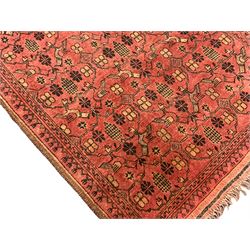 Old Afghan red ground rug, decorated with repeating bird motifs, the guarded border with candelabra pattern (150cm x 104cm); and antique Afghan burnt orange ground rug, field decorated with octagonal lozenges, repeating geometric border (134cm x 95cm) (2)